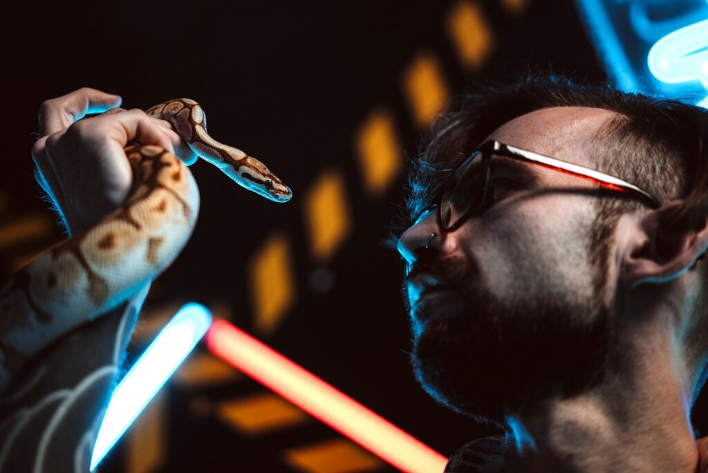 a man holding a snake in his right hand